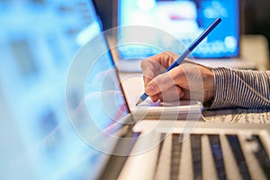 Closeup of a woman`s hand working at a computer in her office