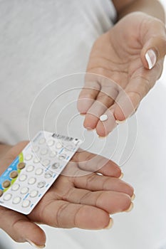 Closeup Of Woman's Hands Holding Pills