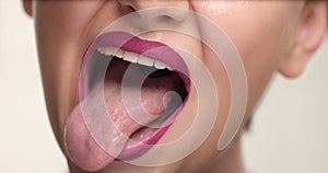 Closeup of woman`s mouth showing a language