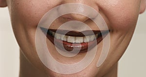 Closeup of woman`s mouth wears chocolate lipstick