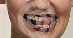 Closeup of woman`s mouth wears chocolate lipstick