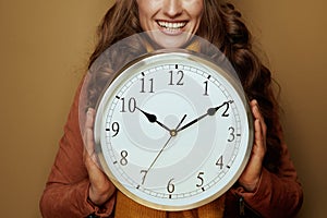 Closeup on woman showing clock remind about autumn time change