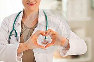 Closeup on woman showing heart shape gesture