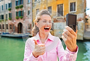 Closeup on woman showing thumbs up in venice, ital