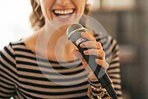 Closeup on woman singing with microphone