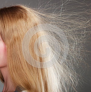 Closeup of woman with static blonde hair.