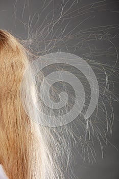 Closeup of woman with static blonde hair.