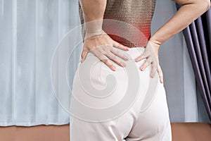 woman suffering from lower back pain, muscle strain photo