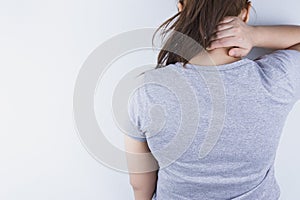 Closeup woman suffering from neck and shoulder pain. Health care and medical concept