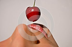 Closeup Of A Woman Tasting A Cherry