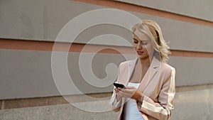 Closeup woman texting message on phone. Businesswoman using phone at street