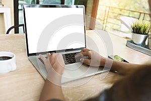 Closeup woman typing on laptop keyboard on desk