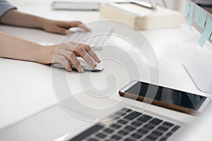 Closeup woman using computer mouse with computer keyboard