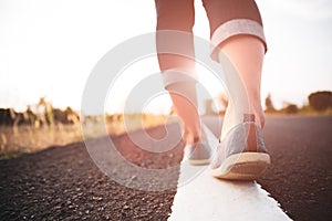 Closeup woman walking towards on the road side. Step concept