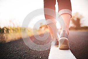 Closeup woman walking towards on the road side. Step concept