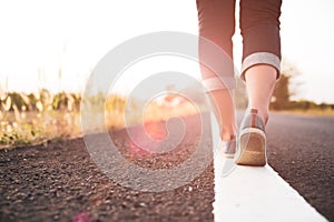 Closeup woman walking towards on the road side. Step concept