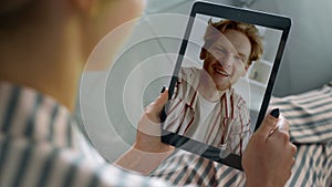 Closeup woman waving hand at tablet at home. Cheerful young family videocalling