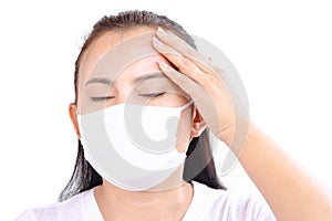 Closeup woman wearing face mask for protect air polution or virus covid 19 with headache on white background, health care and