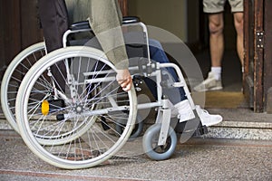 Closeup of woman in wheelchair at an entrance