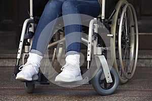 Closeup of woman in wheelchair at an entrance photo