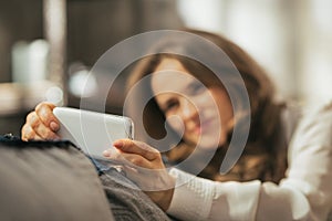 Closeup on woman writing sms in loft apartment