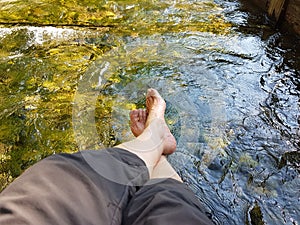 Closeup of womans feet, hardening in a cold mountain brook