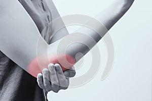 Closeup women elbow pain/injury with red highlights on pain area with white background, healthcare and medical concept B&W filter