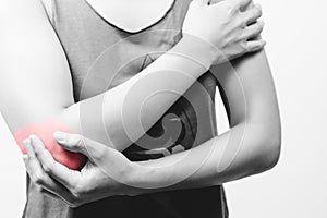 closeup women elbow pain/injury with red highlights on pain area with white backgrounds, healthcare and medical concept - B&W filt