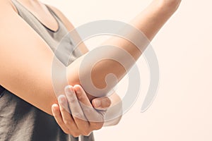 Closeup women elbow pain/injury with white backgrounds, healthcare and medical concept