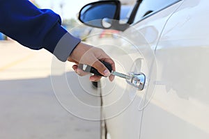 Closeup Women hand holding car key to unlocking or opening car door