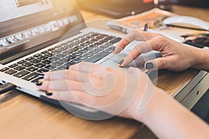 Closeup women hand using laptop touchpad while working