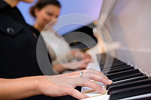 Closeup women playing piano duet