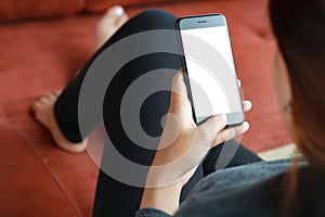 Closeup women use smart phone mobile white screen on sofa decor