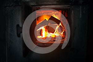 Closeup of wood stove with the burning firewood.