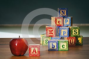 Closeup of wooden blocks and apple
