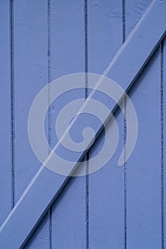 Closeup of wooden blue window shutter in France, useful as a background