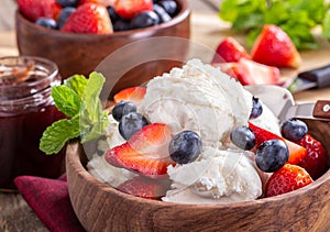 Bowl of Vanilla Ice Cream With Blueberries and Strawberries