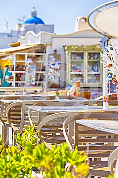 Closeup of Wooden Chairs of Open Air Restaurant Located in Oia Village in Santorini Island in Greece