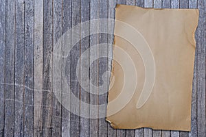 Closeup wooden desk with notice bulletin board, empty blank space on rustic wooden board, mock up of old paper texture, ad, advt