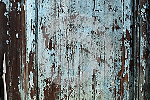 Closeup of a Wooden Door with Peeling Blue/Teal Paint