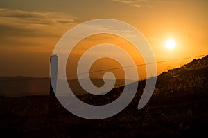 wooden fence silhouette at the top of themountain on sunset background