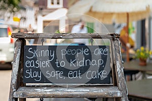 Closeup of a wooden frame with a text board in a street