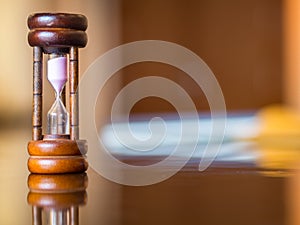 Closeup wooden hourglass on the table,