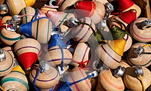Closeup of wooden humming tops with threads in a box under the sunlight