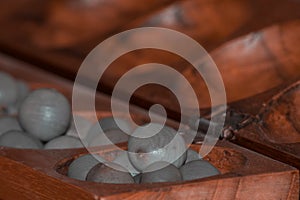 Closeup of a wooden mancala game