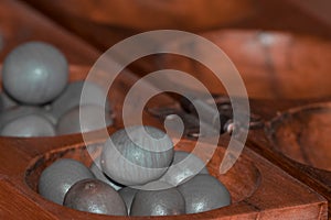 Closeup of a wooden mancala game