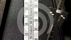 Closeup Of Wooden Metronme Showing Tempo Settings photo