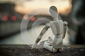 Wooden puppet in cityscape sunset - concept relaxatio photo