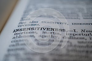Closeup of the word insensitiveness