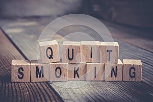 Closeup Of The Words Quit Smoking Formed By Wooden Blocks On A Wooden Floor